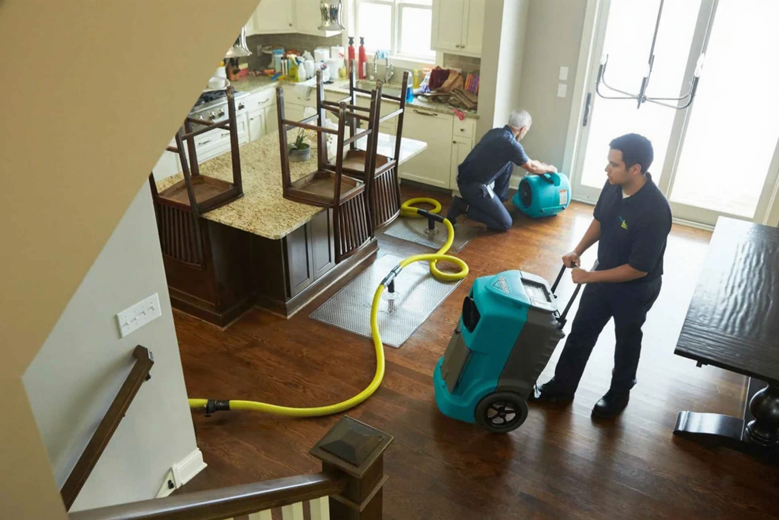 Restoration technician reviewing written scope of work estimate in water-damaged Austin home