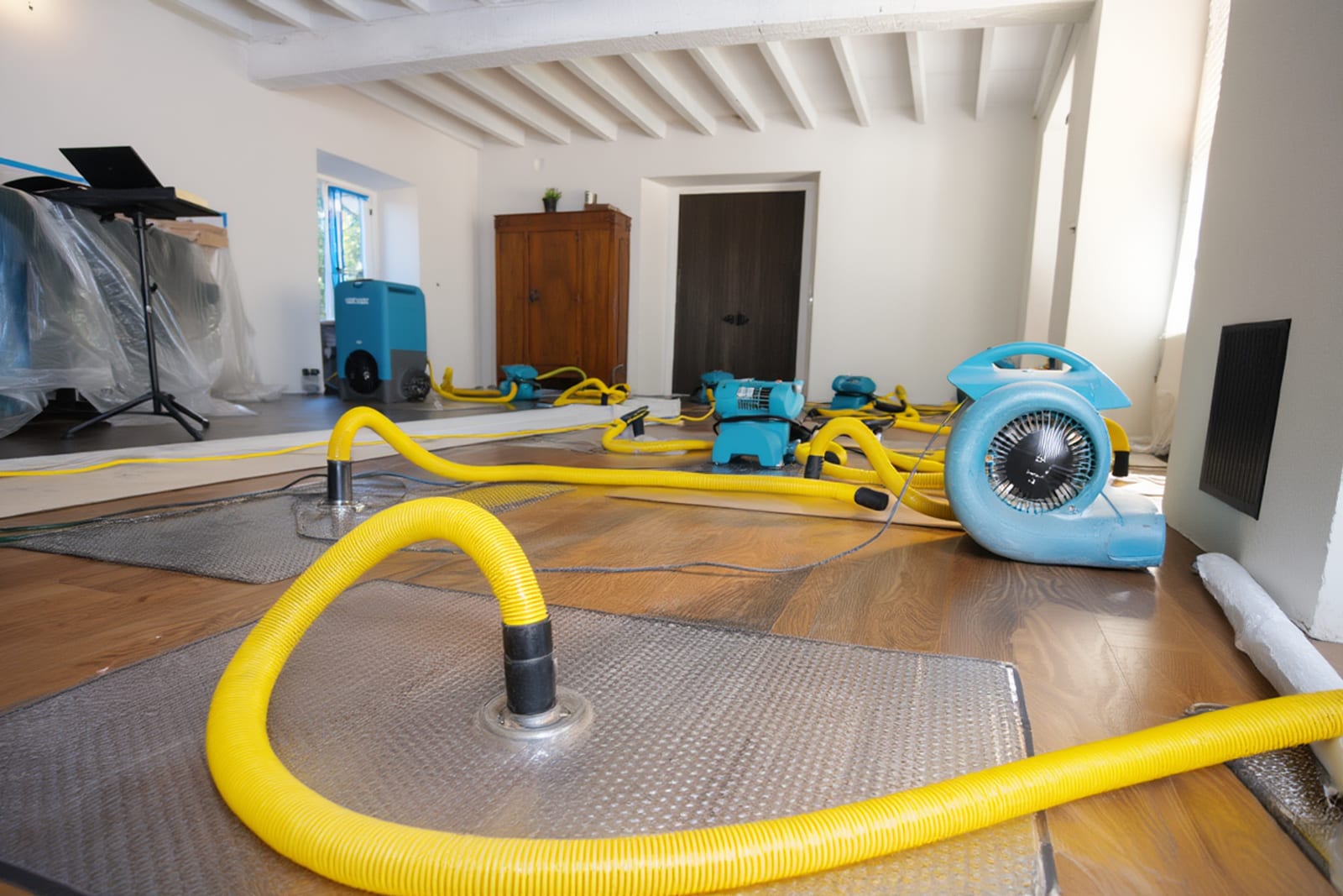 Technician using thermal imaging camera to map hidden moisture during water damage assessment in Austin home