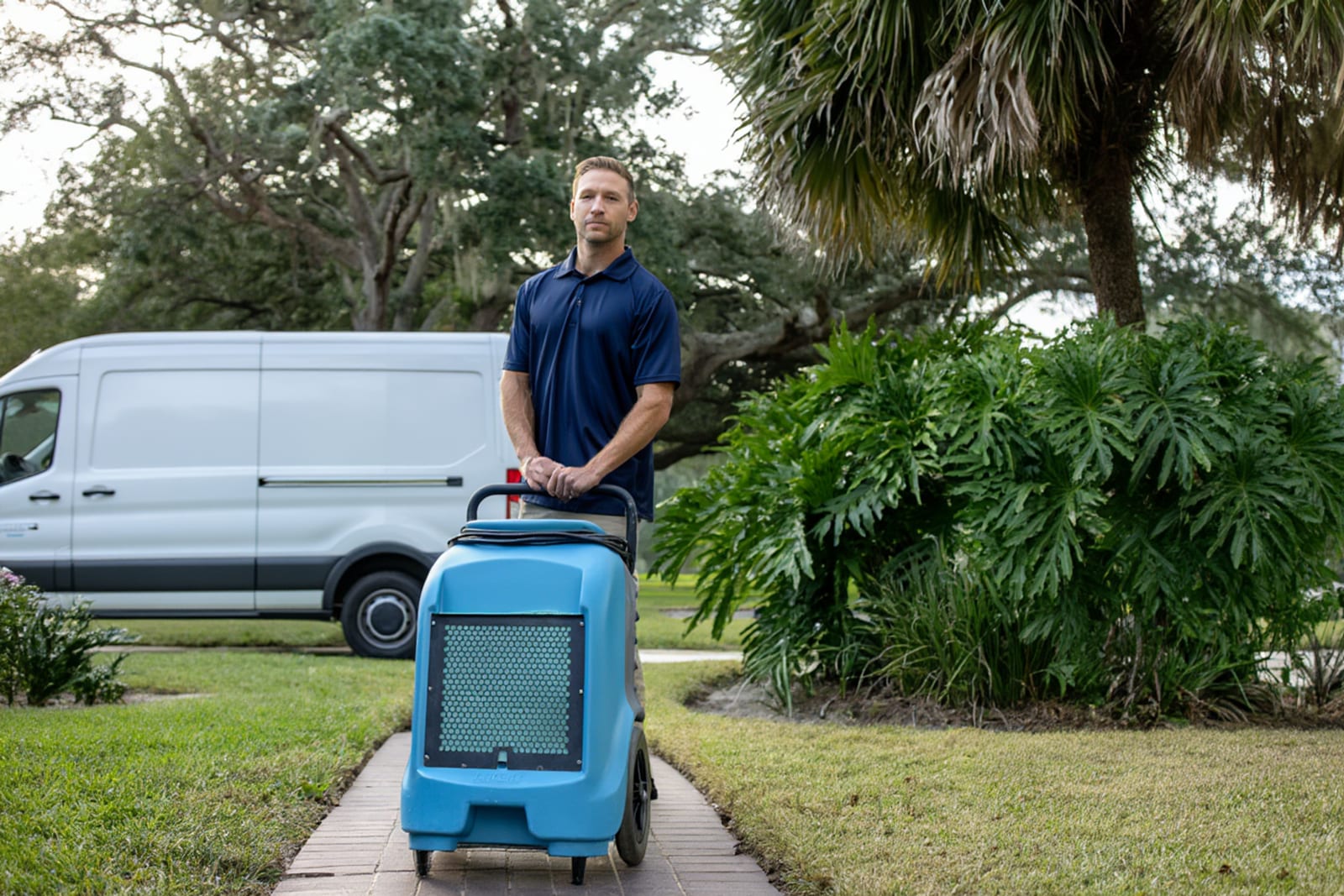 Restoration professional using moisture detection equipment to assess hidden water damage in Austin home